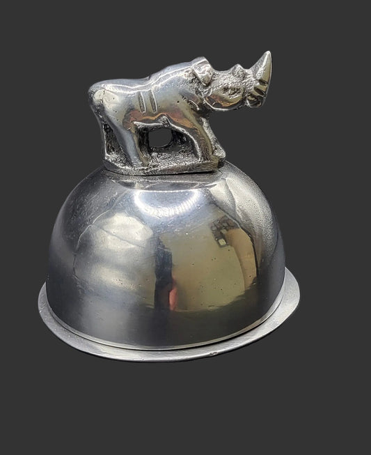 Metallic bell with a rhino figure on top