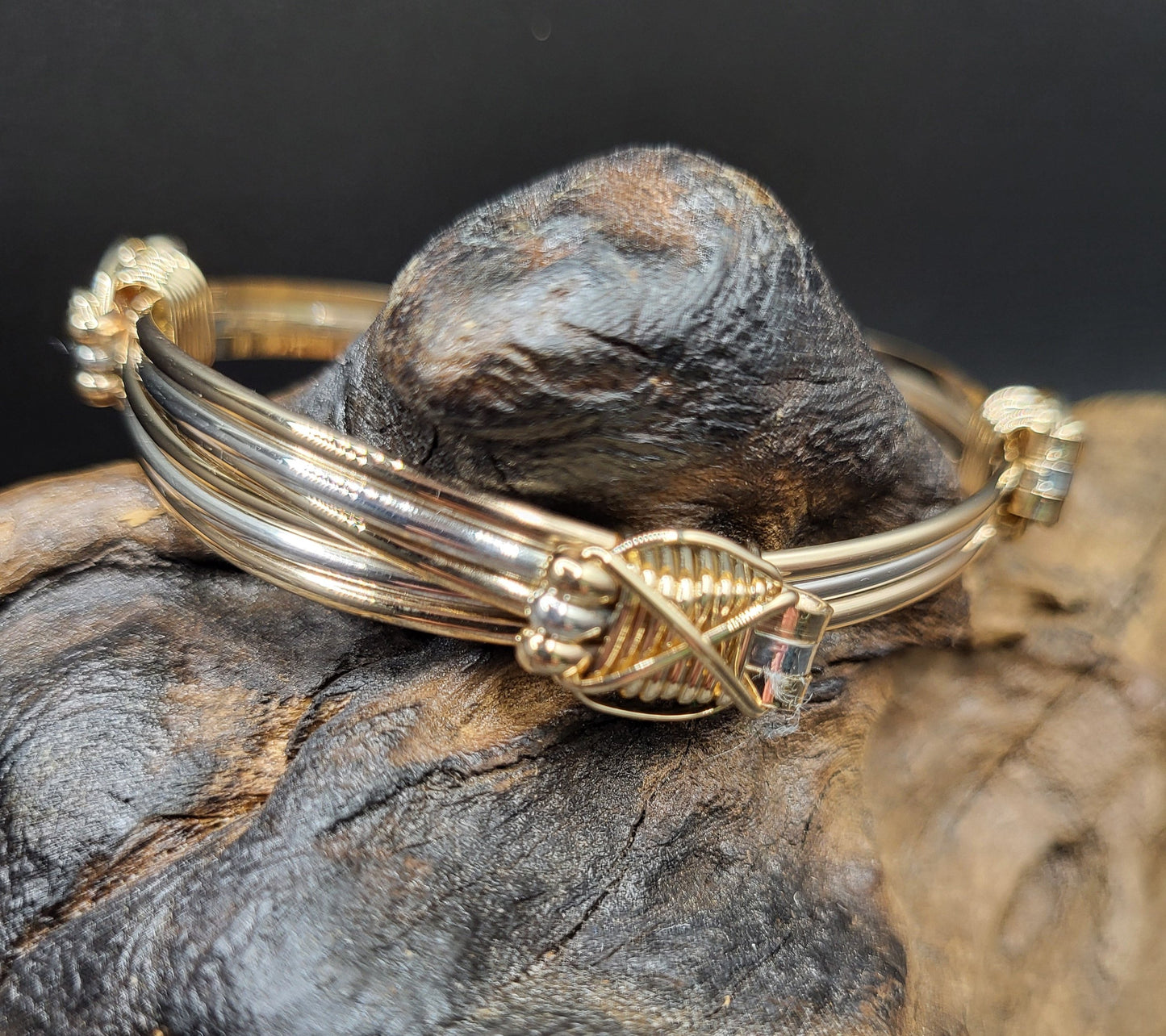 Elephant hair bangle side view atop wood