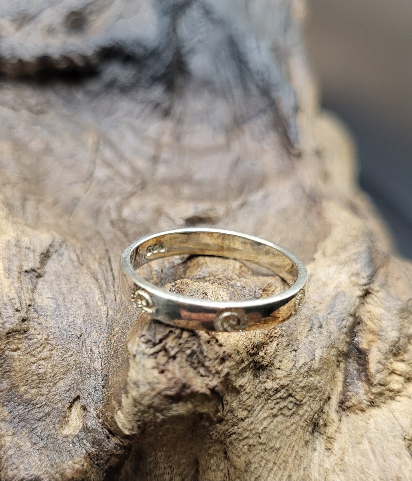 Silver Stacking Ring Sitting On Wood